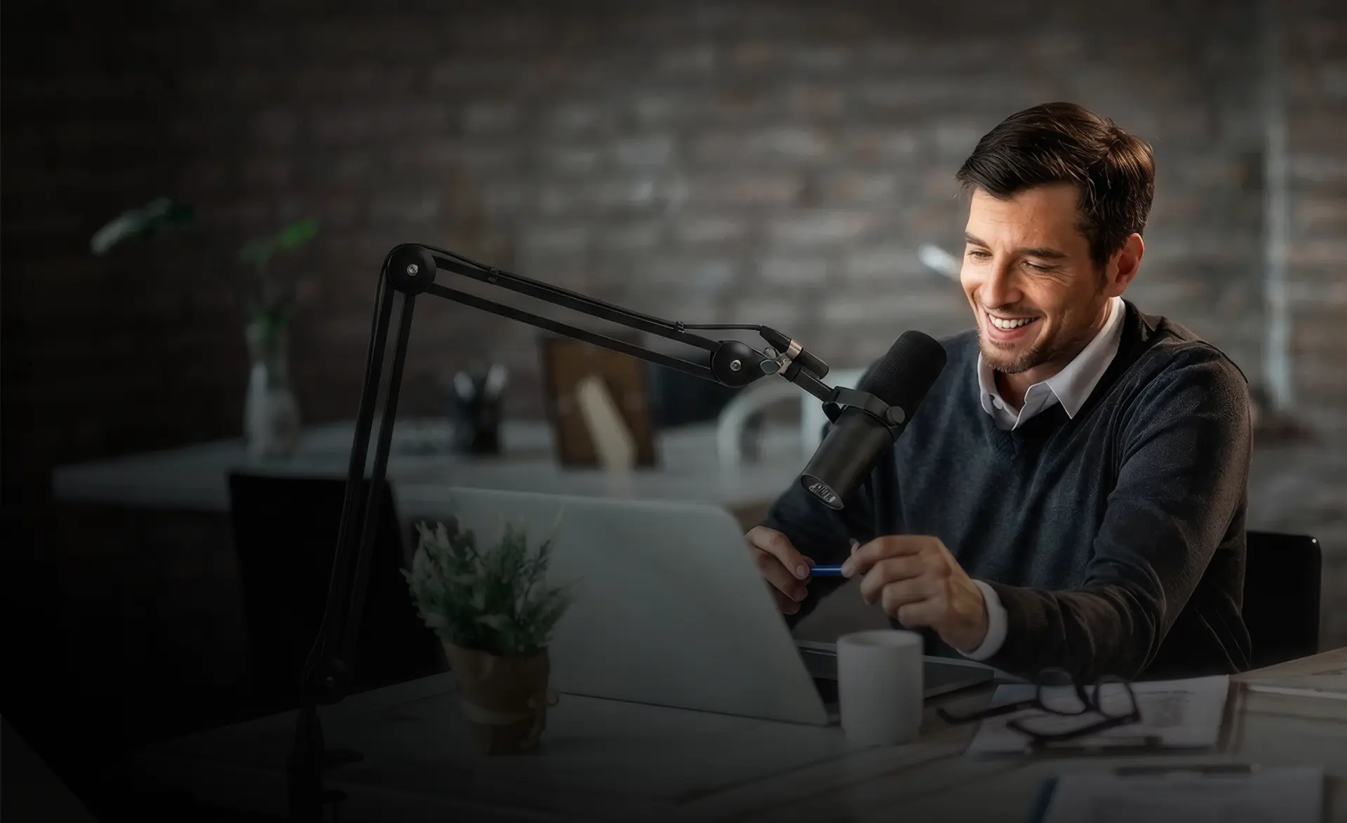 Creator recording a podcast episode at a studio desk